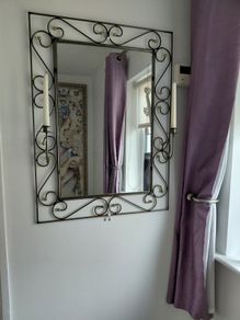 Wrought iron mirror with candle stands either side
