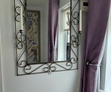 Wrought iron mirror with candle stands either side