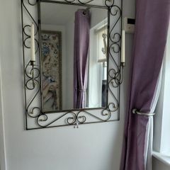 Wrought iron mirror with candle stands either side