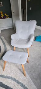 Scandinavian-style wingback armchair with a matching footstool