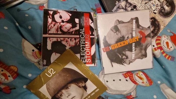 bag of U2 promo CD singles, CD albums and DVD sets