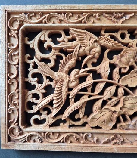 Carved decorative wooden panel, featuring birds.