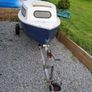 Small boat with engine and trailer Image 2