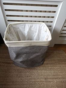 Laundry bag with rope handles. Grey and cream fabric.