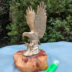 Vintage cast brass eagle on bog oak