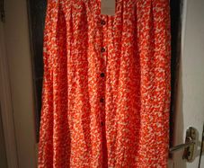 Asos Printed Crepe Midi Skirt features an orange ditsy floral print and a button down front. New with Tags