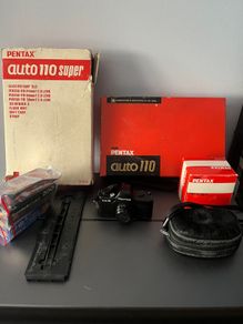 3 Pentax Auto 110 film cameras and accessories boxed