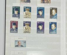 Collection. Brown stock book with collection of stamps celebrating Winston Churchill. Most are mint never hinged (MNH)