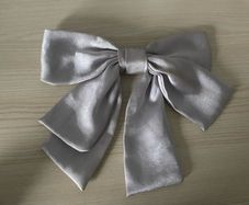 Elegant silver-grey satin hair bow barrette with French clip, gently used and in great condition