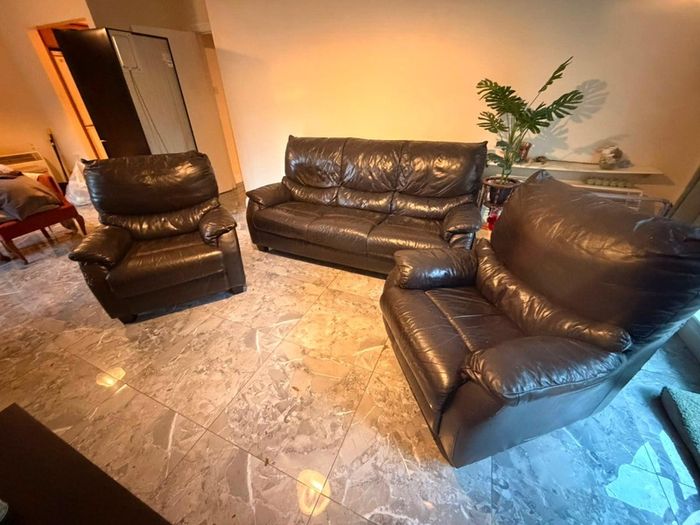 black leather sofa and arm chairs