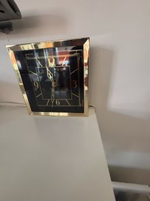 Gold clock with black face