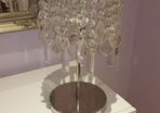 Chrome table lamp with glass pendants.