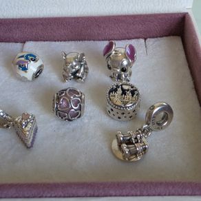 Pandora charms in great condition.Selection includes Disney Stitch (enamel & figure), cute elephant, purple heart openwork, cake slice dangle, Hogwarts castle, and binoculars dangle (Good times on the horizon) 18e each charm