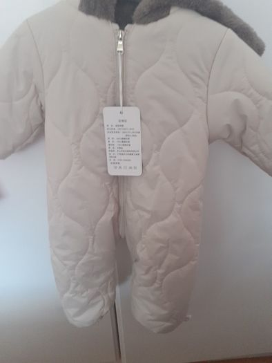 New unisex snow suit beigh with brown fur lining .Never worn size 0-3 months