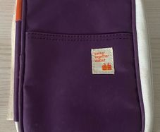 travel organizer wallet in purple with multiple card slots and mesh pockets