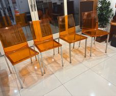 Four striking chrome and plastic orange vintage Italian dining chairs. Very decent and useable condition. A bargain at this price.