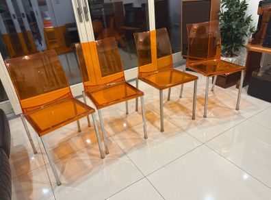 Four striking chrome and plastic orange vintage Italian dining chairs. Very decent and useable condition. A bargain at this price.