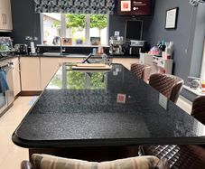 Black  polished and sealed granite with fleck throughout and bullnose finish Countertops / island / splash back and upstands