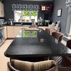 Black  polished and sealed granite with fleck throughout and bullnose finish Countertops / island / splash back and upstands