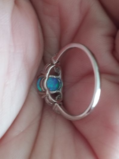 Ring made of 925 silver with oval opal of blue shade and cubic zirconia.