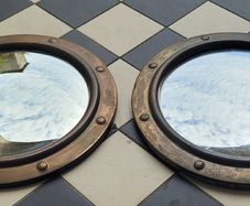 Antique pair of brass convex mirrors
