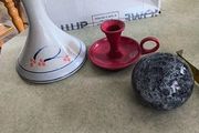 3 different itmes- 1- pottery modern design handmade candle holder 18.00 euro. 2-  red enamel candlestick holder and drip tray featuring a Considered by Helen James 12.00 euro. 3-  PAPERWEIGHT 15.00 euro