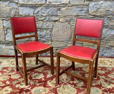 A pair of mid century leatherette kitchen chairs.