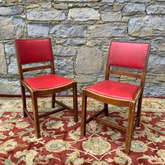 A pair of mid century leatherette kitchen chairs.