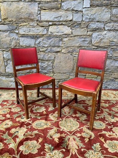 A pair of mid century leatherette kitchen chairs.