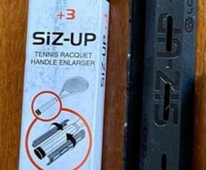 Tennis racket handle enlarger
