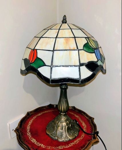 Tiffany-style stained glass table lamp featuring a floral motif