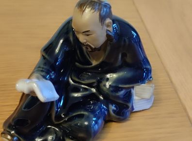 Vintage Figurine man reading book