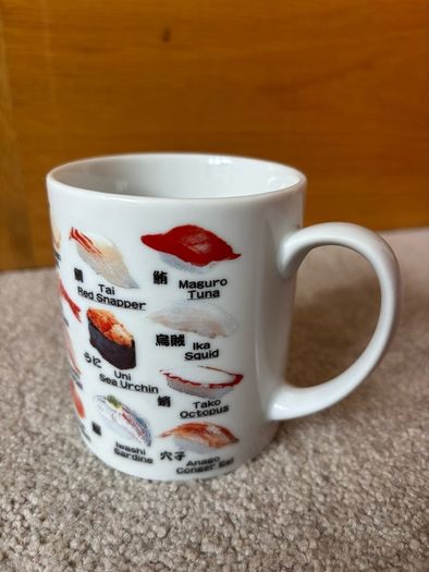 A Mug Featuring Different Types of Sushi
