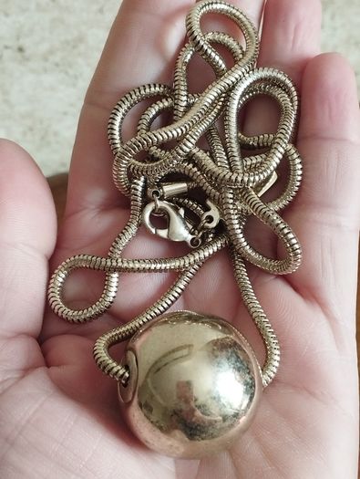 BEN DE LISI long necklace with a ball pendant.