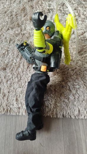 Limited edition This Action Man Air Patrol figure from Hasbro is a 12-inch electronic toy featuring a propeller backpack.The figure wears a distinctive neon yellow and gray flight suit and includes a helmet with a yellow visor.