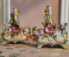 19th century pair of handpainted floral cherub porcelain candleholder/budvases