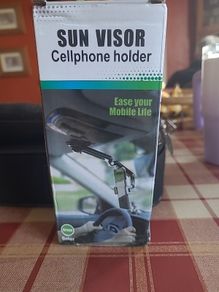 Sun visor mobile phone holder