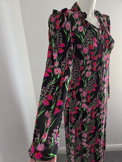 New. Warehouse Size 8 Black Floral print dress with frill trim.