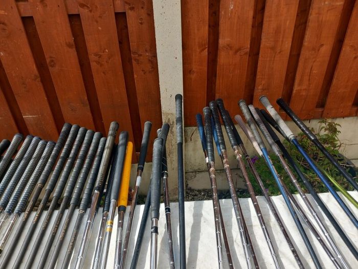 A selection of Golf clubs. Bags and golf balls.