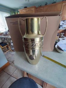 Neoclassical style embossed brass vase - of amphora form, the cylindrical neck flanked by two handles, tapering to an embossed, foliate body, 33cm,