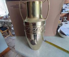 Neoclassical style embossed brass vase - of amphora form, the cylindrical neck flanked by two handles, tapering to an embossed, foliate body, 33cm,