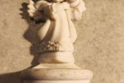 A holy water font  a small cherub angel statue .small religious decorative item,