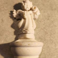 A holy water font  a small cherub angel statue .small religious decorative item,