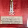 antique framed crucifix featuring a white ornamental cross with a metallic corpus of Jesus Christ mounted over a red  backing inside a gilded wooden frame. Devotional item. Image 3