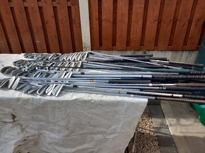 A selection of Golf clubs. Bags and golf balls.