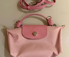pink Longchamp Le Pliage mini top-handle bag with a detachable shoulder strap