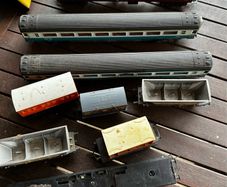 Some random parts for hornby trains. Included is 2 British rail coaches in need of repair. A Harry Potter coach. Also various goods trucks