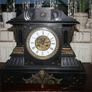 Victorian French Black Slate Mantle Clock (Very large and heavy) with bronze ornamentation Oversized. Open escarpment slate plate Roman numerals. Circa 1890s. Accented with Trojan head. Flanked by two Hellenistic ladies heads on sides. Rose cartouche mask Image 5
