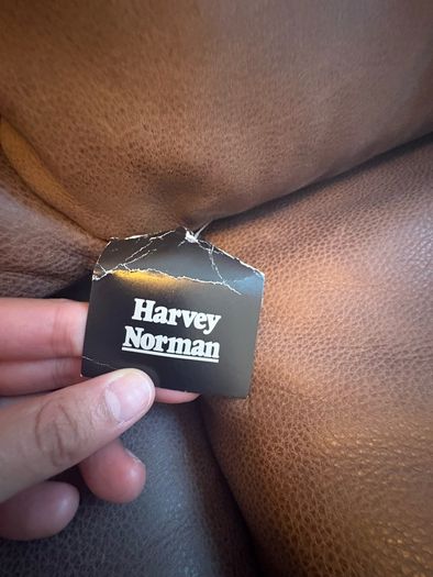 Leather sofa with original harvey Norman tag still attached
