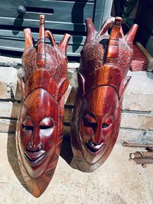 Two carved tribal masks